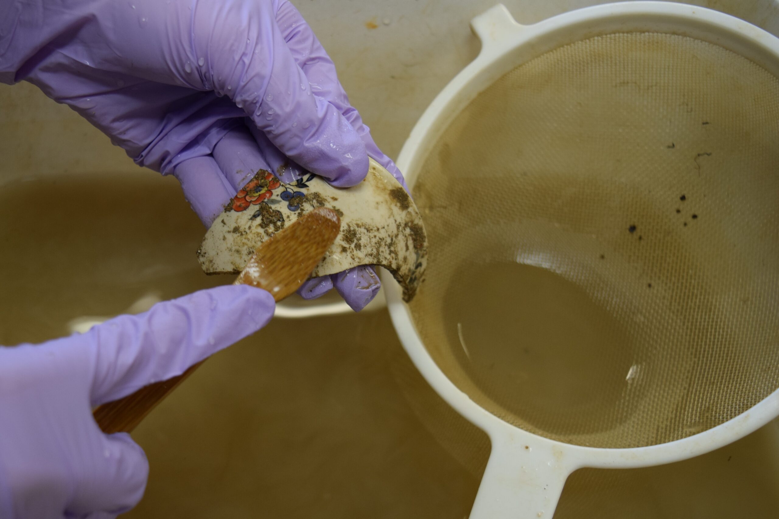 artifacts being washed with a toothbrush